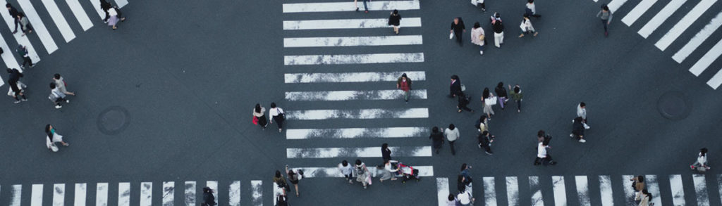birds eye view of an intersection with people crossing