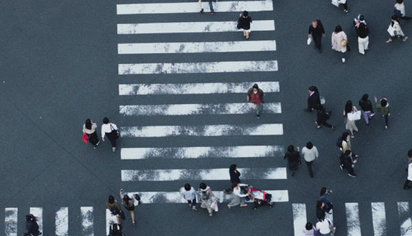birds eye view of an intersection with people crossing