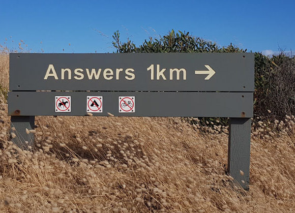a signpost to 'Answers', 1km away