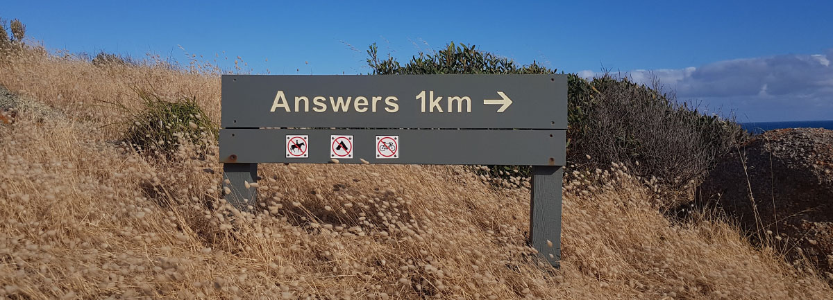 a signpost to 'Answers', 1km away