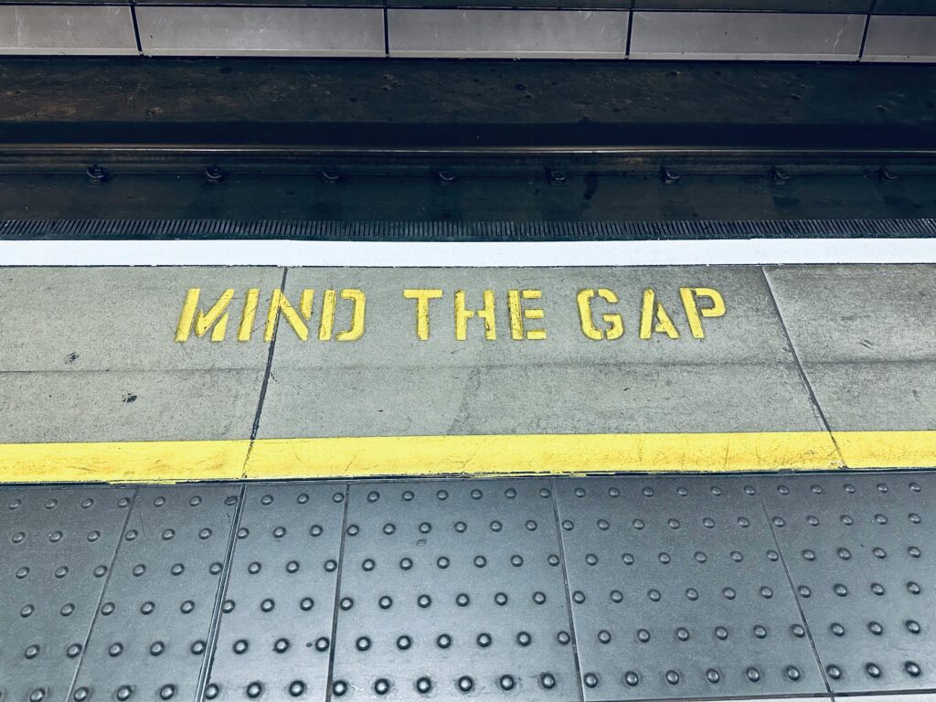 MIND THE GAP written on at train station / underground platform.
